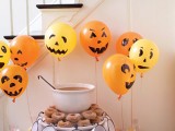 a dessert table style din chocolate brown and orange, with ghost balloons and bright napkins