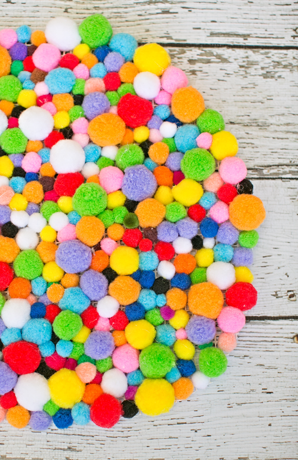 Picture Of colorful and easy diy pompom rug  7
