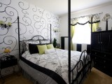 graphic black and white patterned wallpaper matches the monochromatic bedroom and bright yellow touches