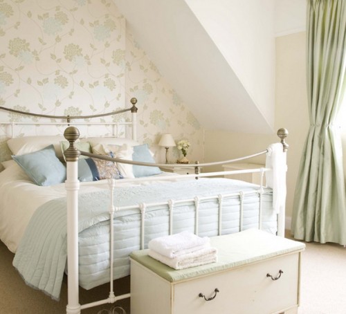 a neutral bedroom with a subtle floral accent wall, matching curtains and printed bedding