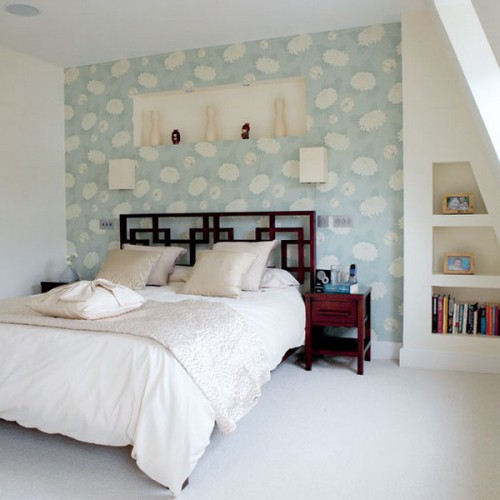 a neutral bedroom with a blue printed headboard wall that brings in a touch of color and pattern to the space