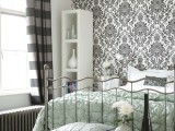 a monochromatic room with a printed wallpaper wall that matches the color scheme and brings interest to the space