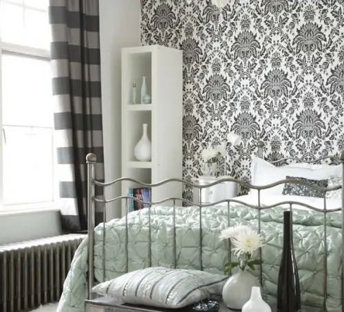 a monochromatic room with a printed wallpaper wall that matches the color scheme and brings interest to the space