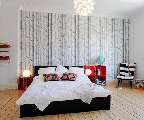 a neutral bedroom with a black and white printed wallpaper wall that adds catchiness to the space