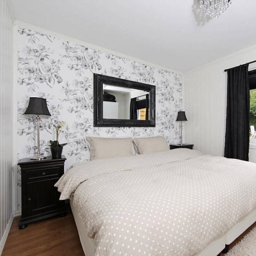 a monochromatic bedroom made much more interesting and eye-catchy with a botanical print wall
