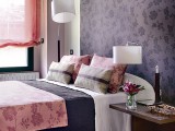 a purple floral statement headboard wall brings color and chic to the space and adds pattern