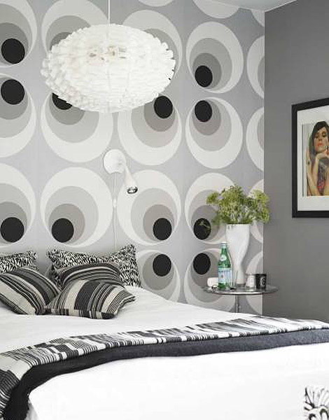 a grey bedroom with a geometric accent wall that makes the space look trendy and fresh