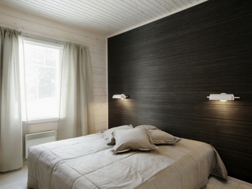 an accent wall covered with dark wallpaper reminding of wood grain is a veyr fresh and unusual solution
