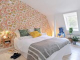a quirky floral wallpaper wall brings color and pattern to the neutral space and makes it more cheerful