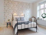 a neutral bedroom with a floral accent wall that brings in pattern and makes the space interesting and catchy