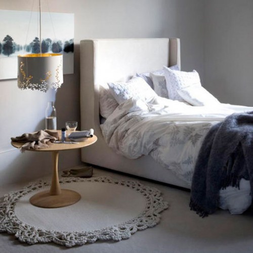 a white laser cut pendant lamp adds a whimsy touch and a chic look to the bedroom