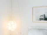 a fluffy hanging sphere lamp brings in some light and softens the interior design with its shape and look