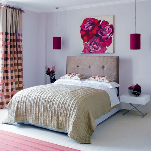 fuchsia-colored hanging lamps over the bed and a matching artwork make the space bolder and cooler