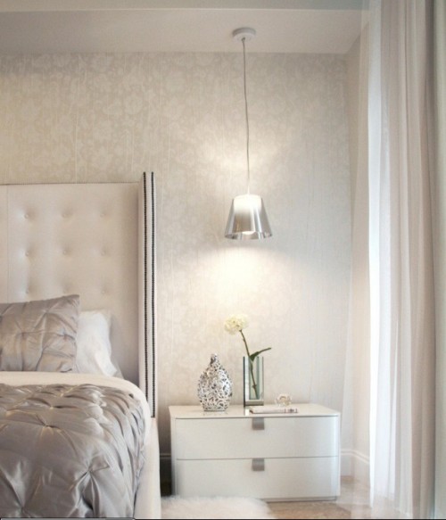 a silver hanging bedside lamp perfectly matches the refined glam interior of the bedroom providing some light