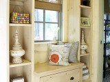 a small windowsill siting space and built-in shelves on both sides of this seat is a cozy nook for reading