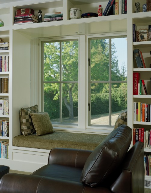 a window sill reading seat with built in bookshelves and a comfortable daybed is a perfect space to have a rest