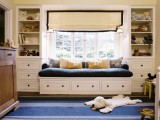 a cozy windowsill space with a large and soft daybed with drawers and built-in shelves on each side is ideal for a kid’s room