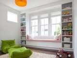 a windowsill reading space with a large daybed with pillows and bookshelves on each side of the bench