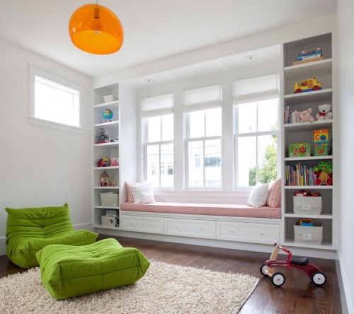 a windowsill reading space with a large daybed with pillows and bookshelves on each side of the bench