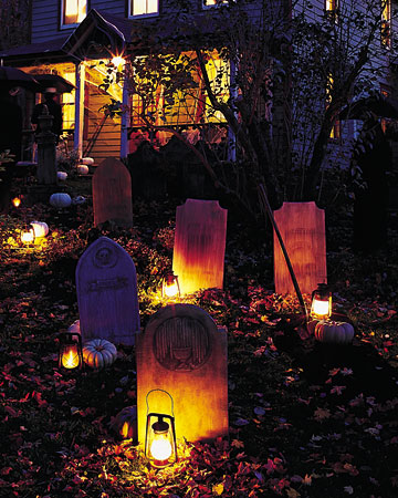 a graveyard with candles and pumpkins is a lovely outdoor decoration to create a mood in the space