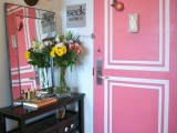 a pink door with white stenciling that makes it bolder, cooler and catchier and adds a refined touch
