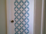 a simple white door can be made catchier and bolder if you add such blue patterns to it