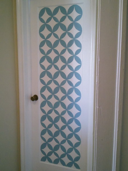 a simple white door can be made catchier and bolder if you add such blue patterns to it