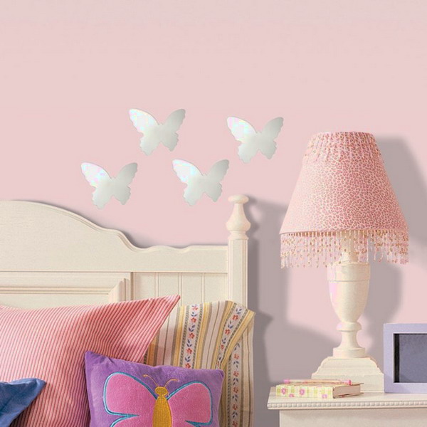 silver butterfly decals on a light pink wall make the space veyr cute and very girlish