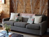whitewashed branches placed behind the sofa to add a natural feel to the living room