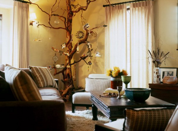 a whole tree trunk in the corner of the room decorated with photos and dreamcatchers will add a boho feel to the space