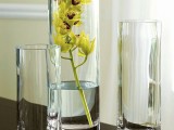 tall glass vases and a vase with a yellow orchid is a refined fall decoration or a refined centerpiece