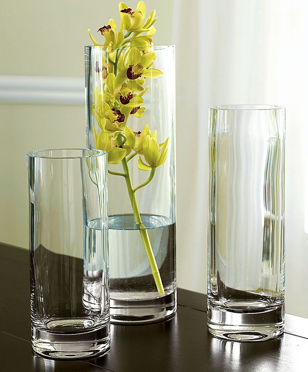 tall glass vases and a vase with a yellow orchid is a refined fall decoration or a refined centerpiece
