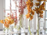 tall vases with bold fall blooms is a cool centerpiece or arrangement for autumn