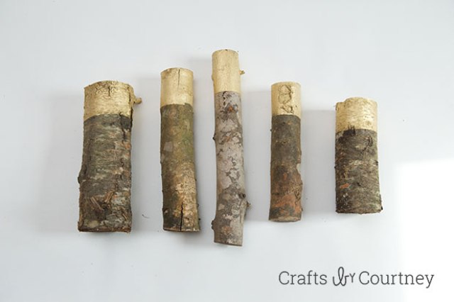 Picture Of diy gold painted logs for rustic decor  4