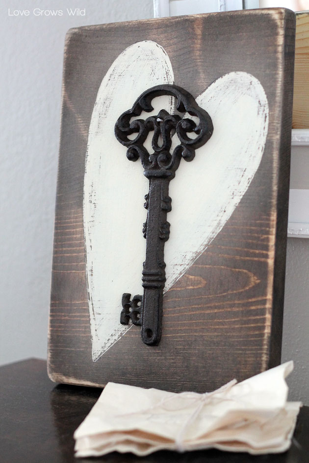 rustic wood sign with a key