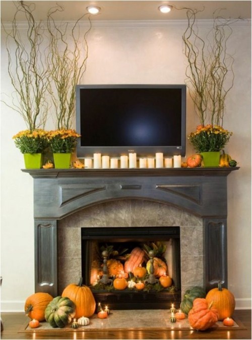 Mix pumpkins, candles, twigs and fall blooms for a beautiful fall mantel. 