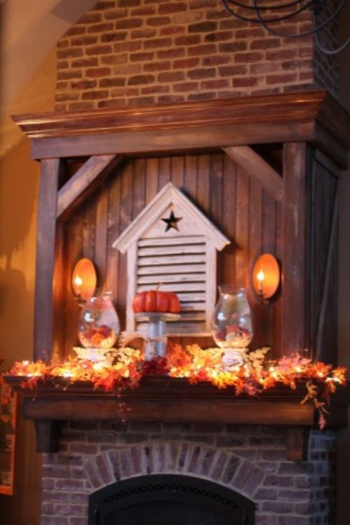 Hide christmas lights among faux leaves so you could light up your mantel any time.