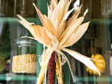 dried corn cobs and husks accent a cabinet for a fall touch, you may also hang them on doors or your front door