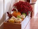 a box with pumpkins, dried corn and fall blooms is a bold rustic decoration you can create for the fall
