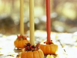 fall colored candles in pumpkins and with pinecones are a perfect craft for the fall