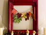 a bold red picture frame with a garland of colorful fall leaves, berries and pears in egg holders