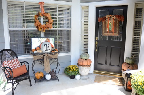 In order to create an interesting Fall display just add a small side table to your porch. Pumpkins are the first thing that comes to our mind when we're deciding what to display on this table.