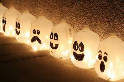 mini ghosts made of milk bottles are creative and fun decorations for a kid Halloween party