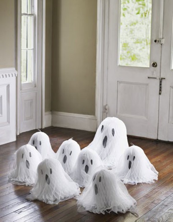 cheesecloth ghosts with scary faces are nice decor for any kind of Halloween party or space