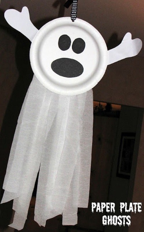 a funny ghost of a paper plate, cloth and some black paper is a fun and easy deocration for a kid's Halloween party