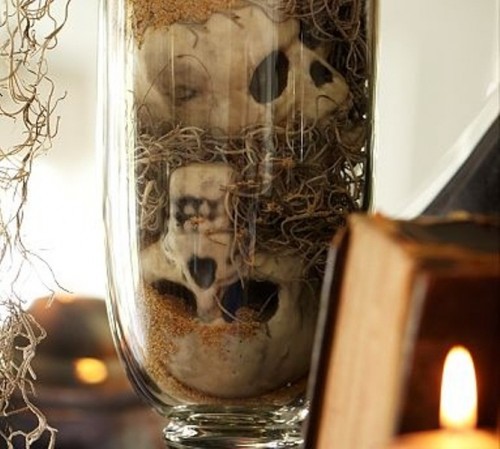 a glass with skeletons and hay is a simple and scary decoration to use for Halloween