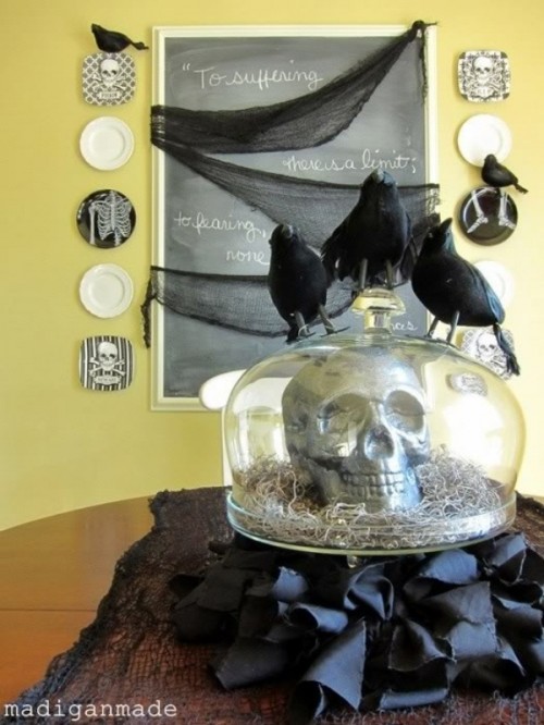 a cloche with a skull and hat plus blackbirds on top is a stylish Halloween decoration