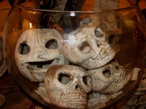 an aquarium with skulls is a stylish Halloween decoration that can be DIYed for cheap