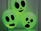 easy ghosts of balloons with scary faces in green are nice decorations for Halloween, they can be used instead of wreaths