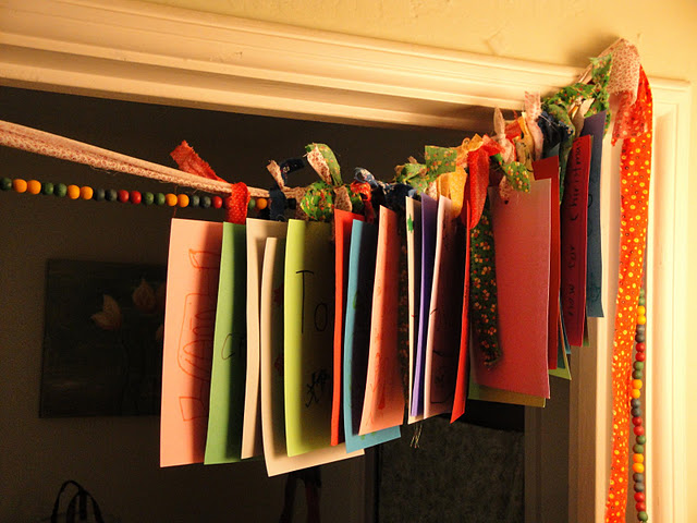 a gratitude garland made of bright papers with wishes is always a good idea for Thanksgiving and you can make it easily